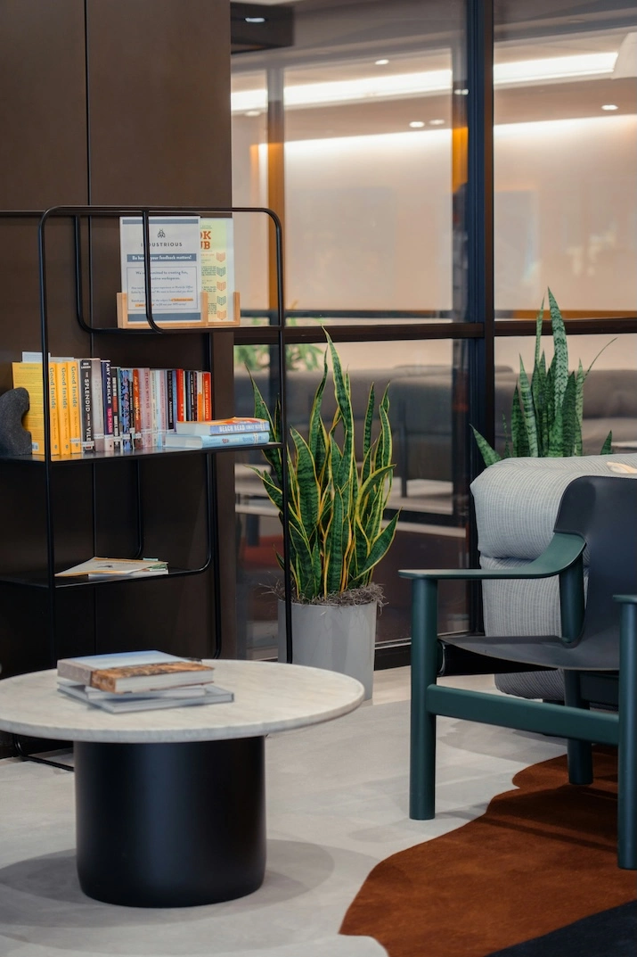 Image of a office space. A small coffee table between two chairs in a modern room
